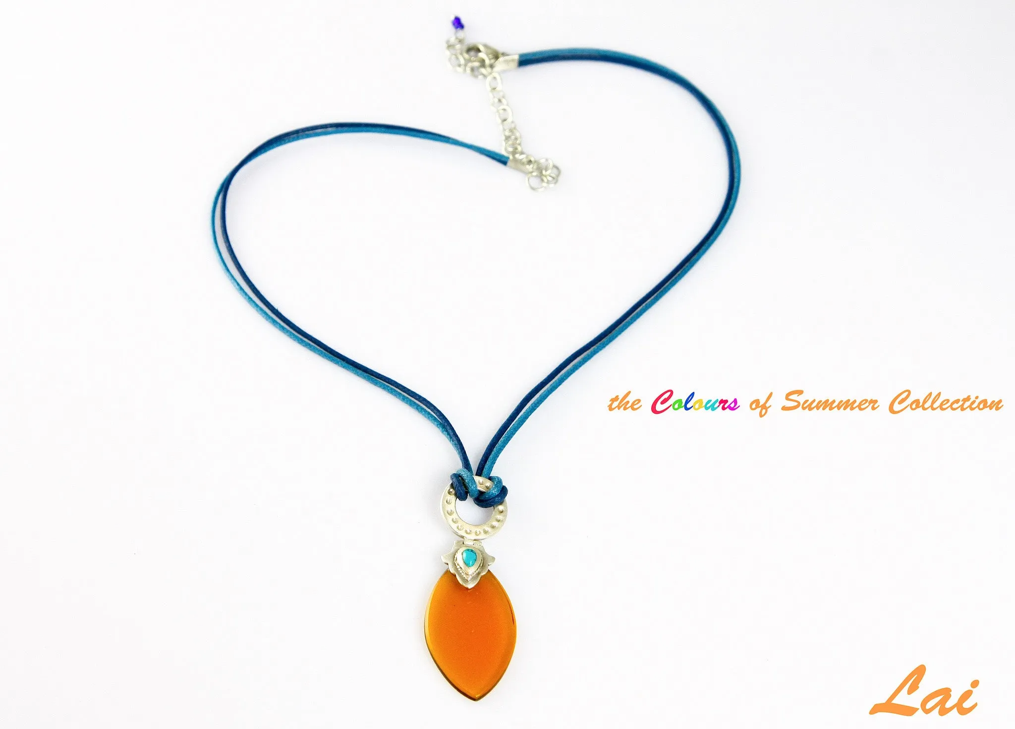 Artistic, navette shape amber colour glass pendant on contrasting blue cord